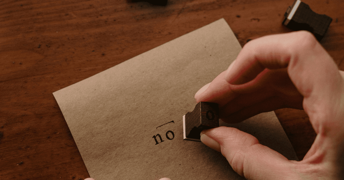 Stamping the word "no" on a brown envelope