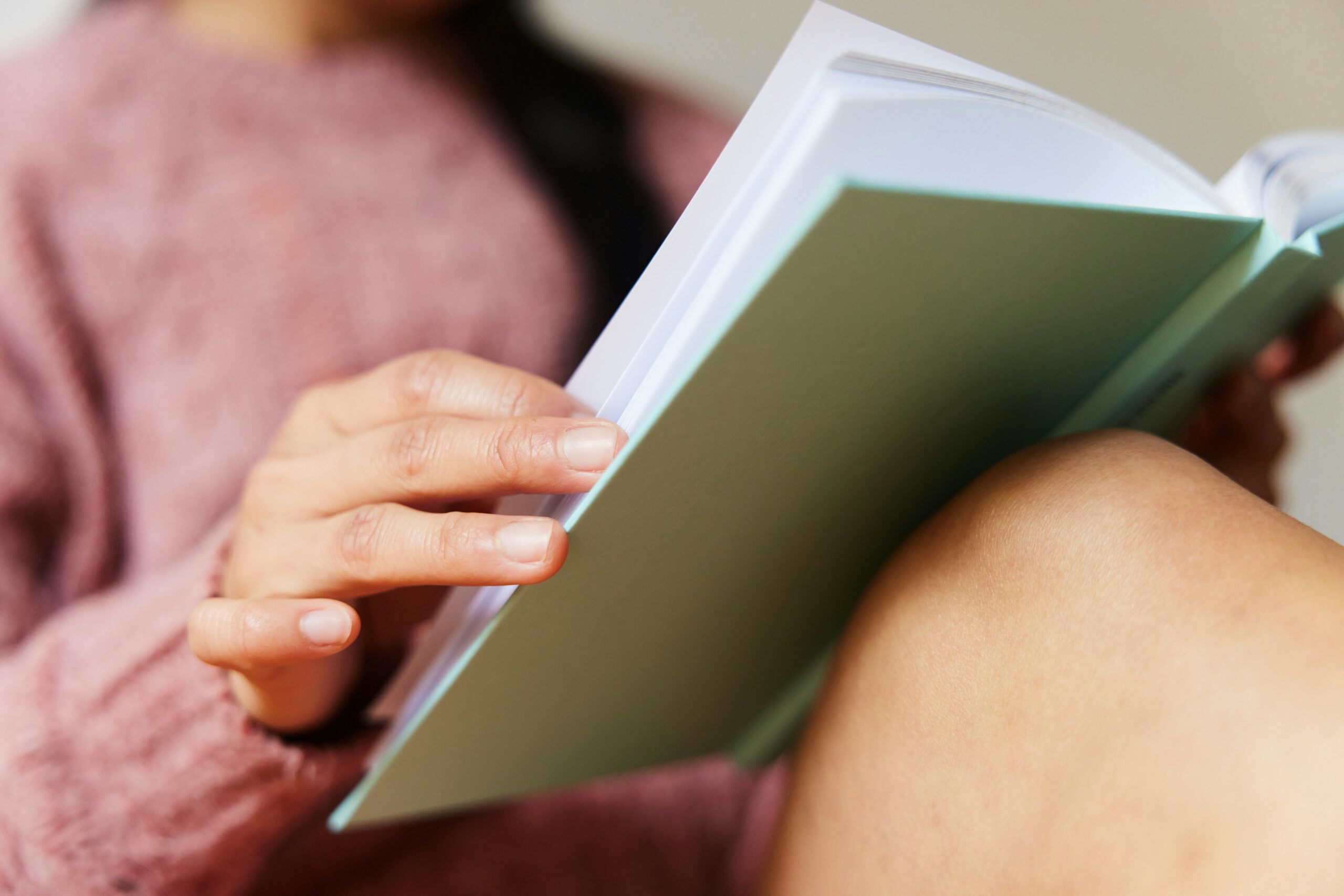 Woman reading a book resting on her knee