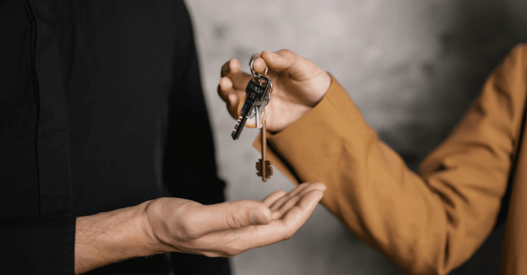 Two people exchanging a set of keys