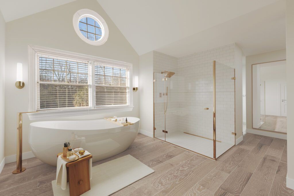 Updated bathroom with freestanding tub and modern white and gold accents and finishings