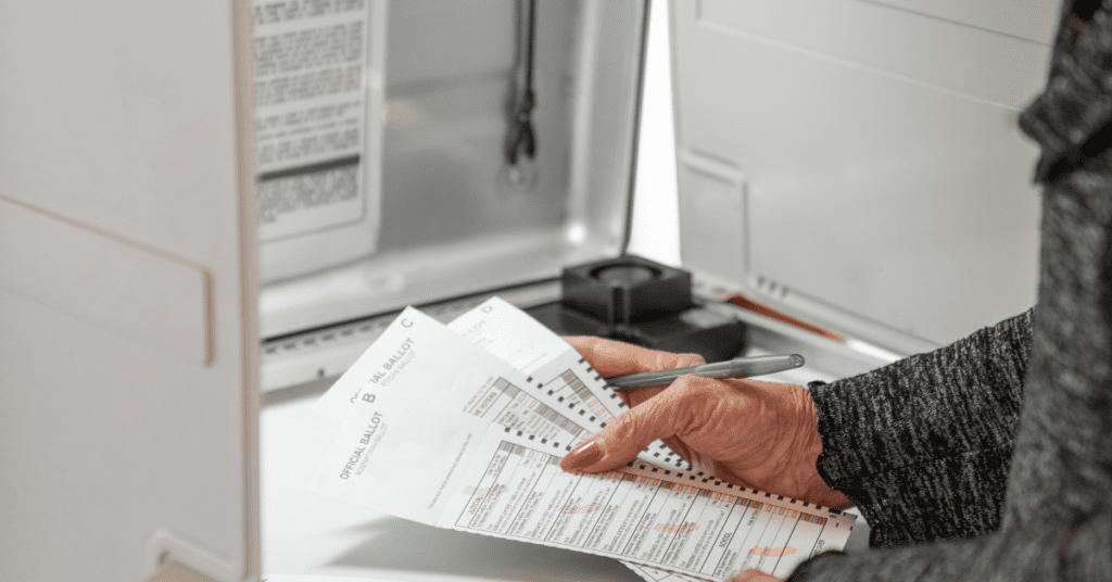 woman completing election ballot