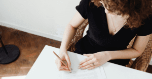 A woman signing paperwork