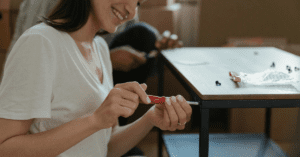 Woman screwing a table together by hand.