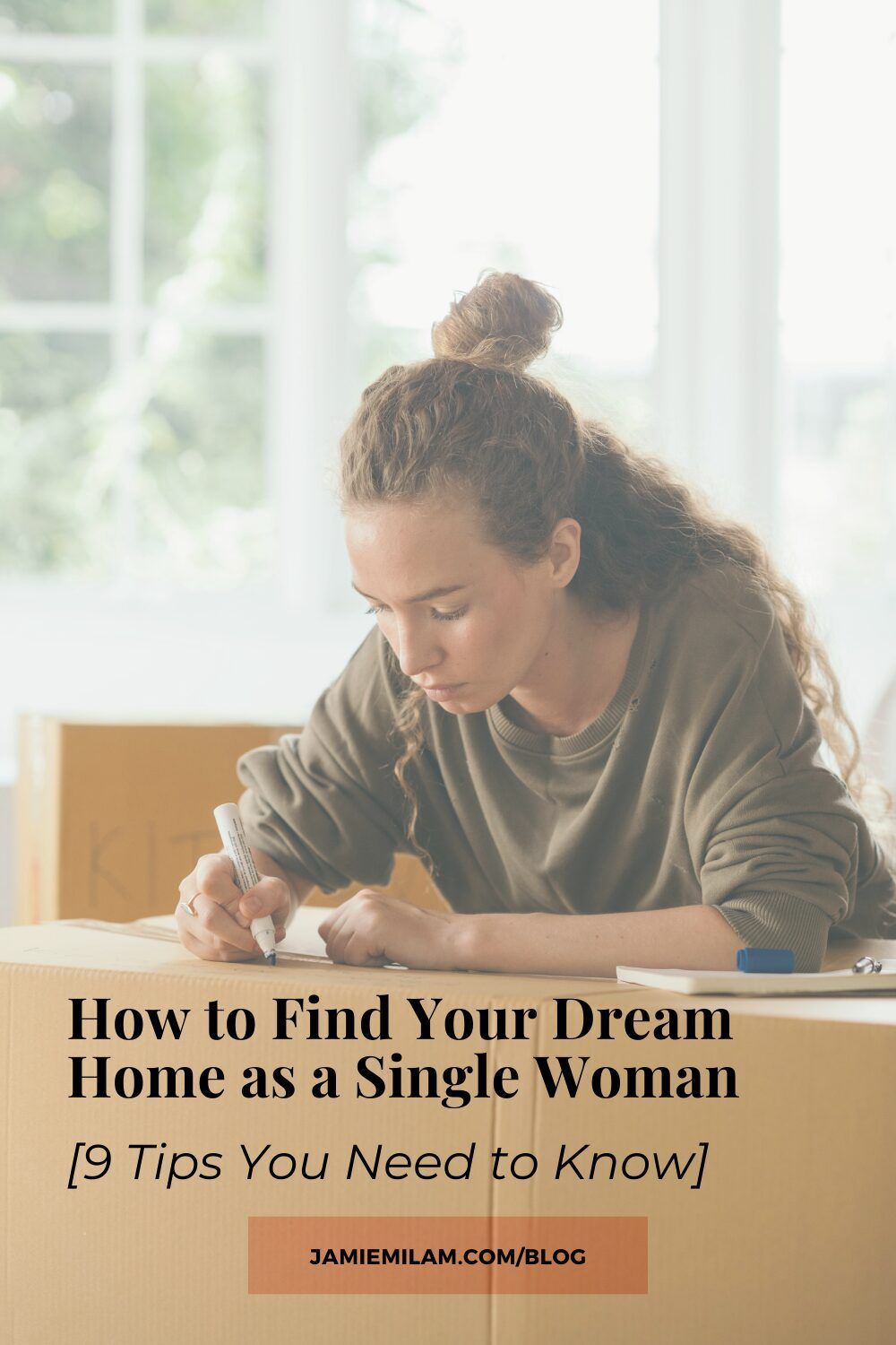 Image of a woman writing on a cardboard box, as if preparing to move, with the text "How to Find Your Dream Home as a Single Woman [9 Tips You Need to Know]"