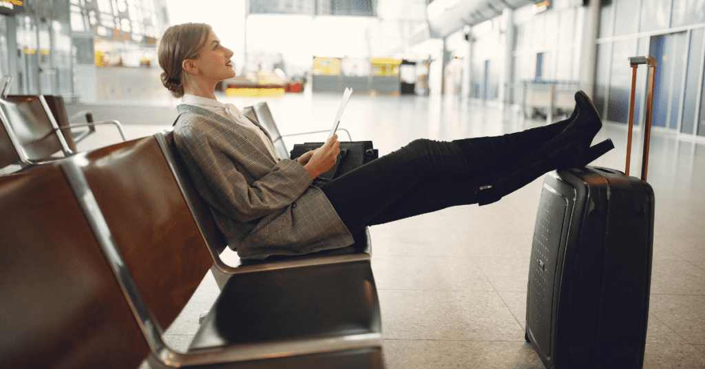 Solo woman traveler at the airport with her luggage