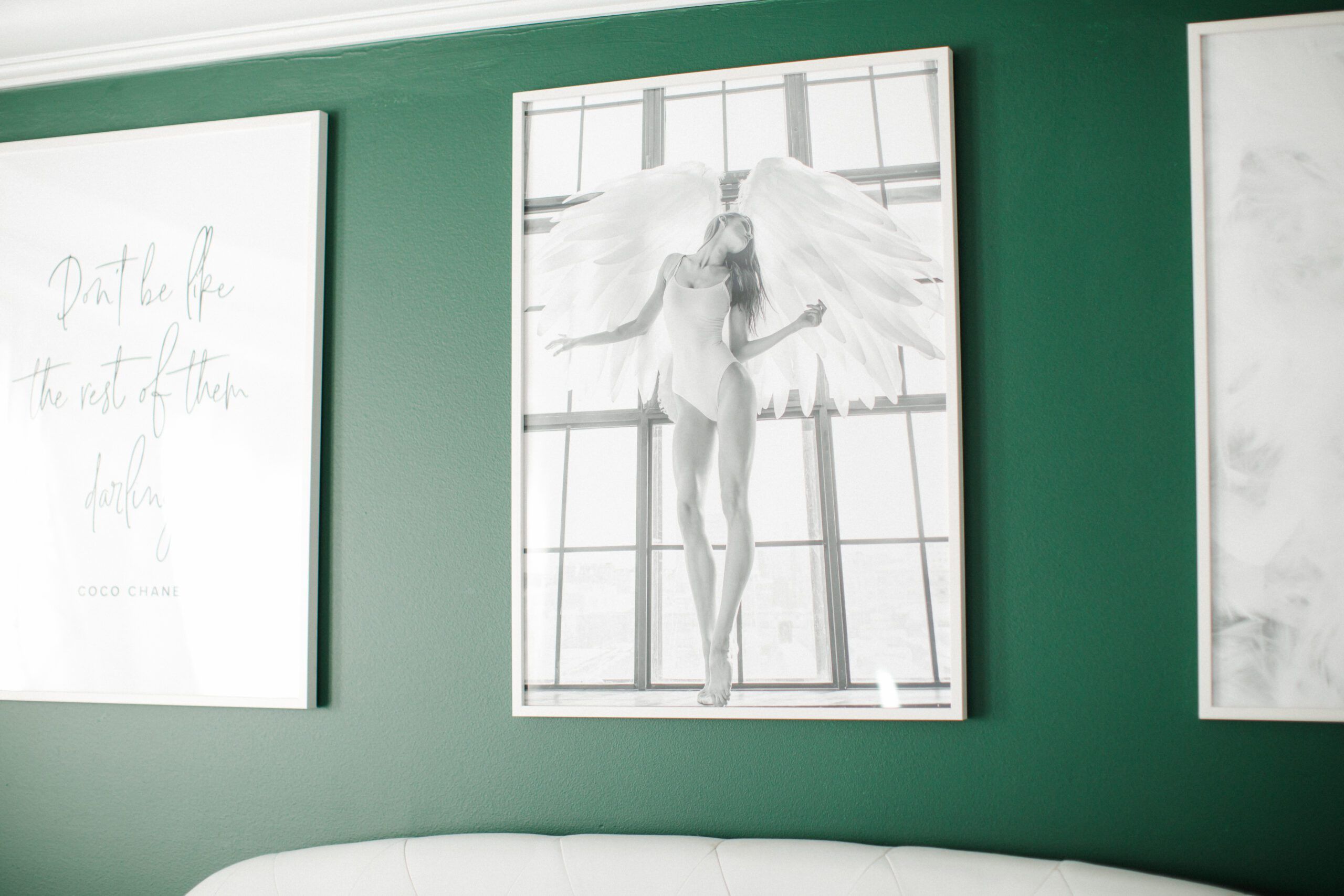 Posters on a green wall in a newly decorated room after a divorce.