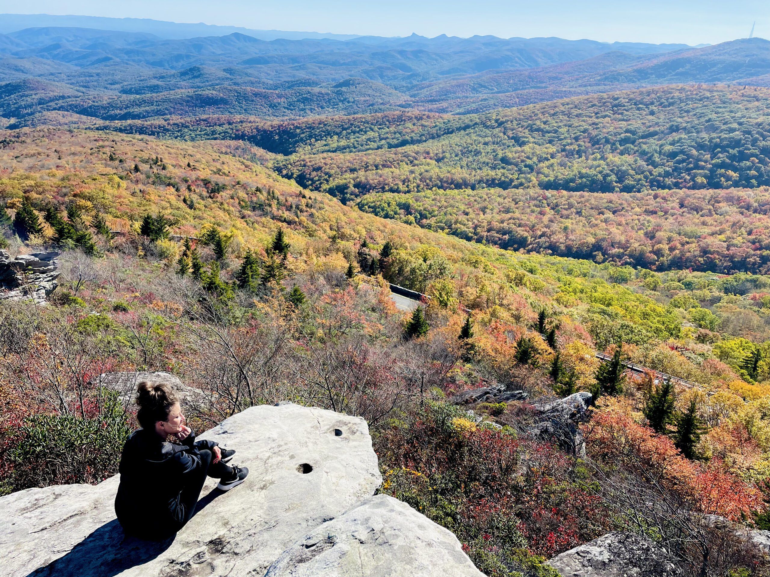 Woman sitting on a rock overlooking Boulder Field on Grandfather Mountain