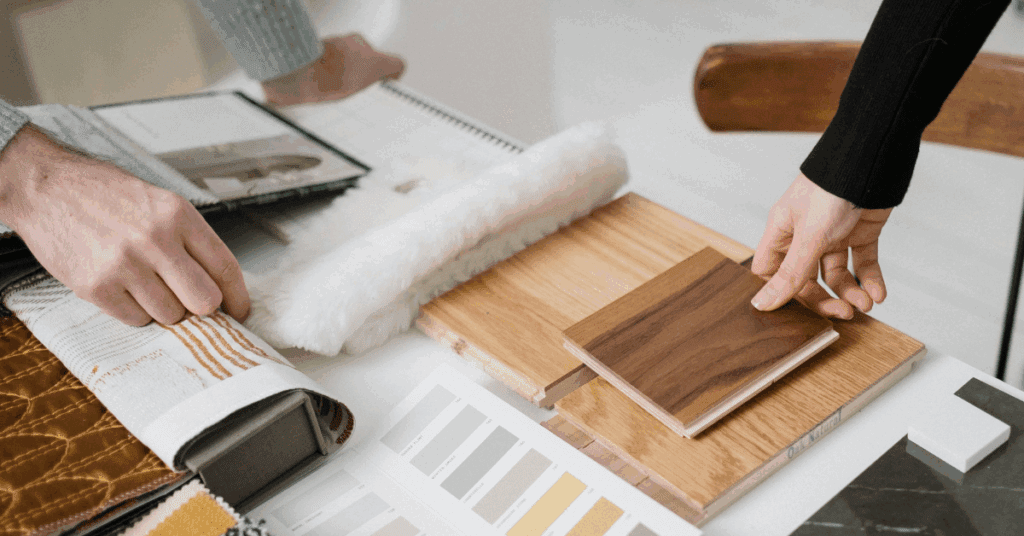 People looking at sample floors and colours on a table, planning for a home renovation
