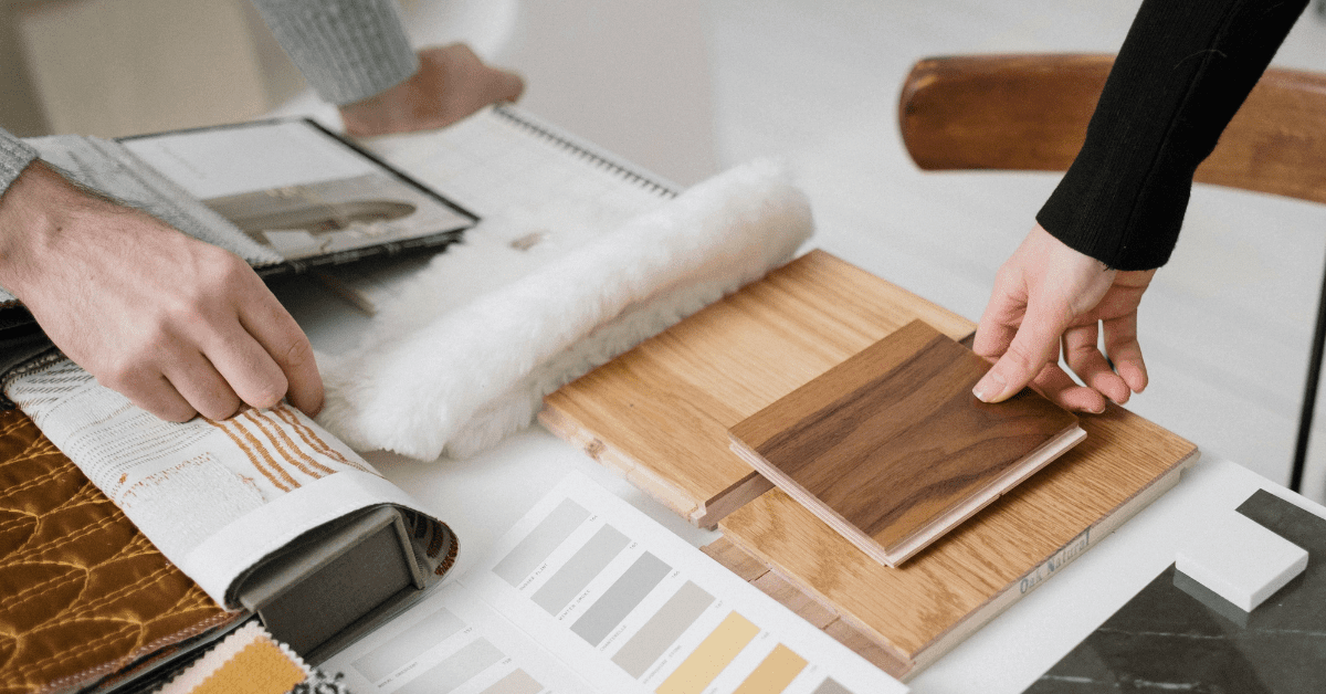 People looking at sample floors and colours on a table, planning for a home renovation