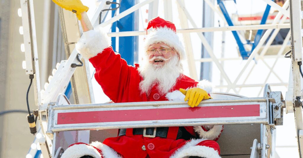 Santa Clause waving his hand from a Ferris wheel
