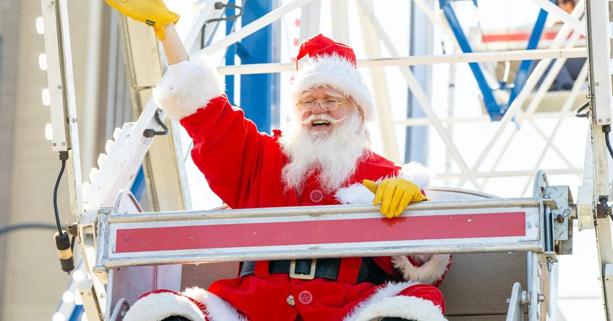 Santa Clause waving his hand from a Ferris wheel