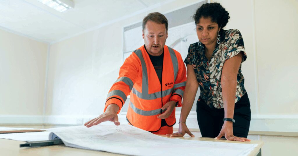 A contractor showing plans to their client
