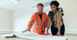 A contractor showing plans to their client