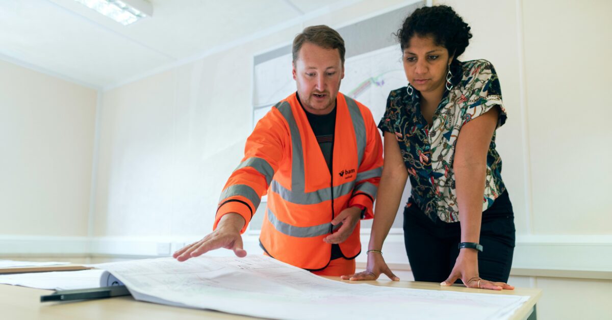 A contractor showing plans to their client