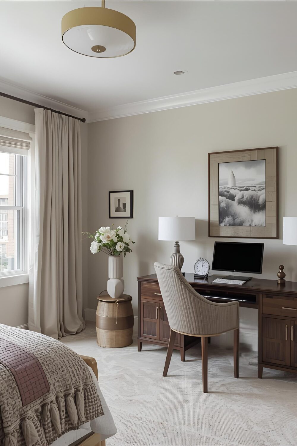 A staged guest room with an desk and chair for a workspace