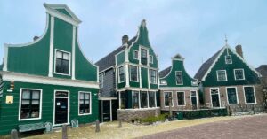 A row of green buildings in Amsterdam