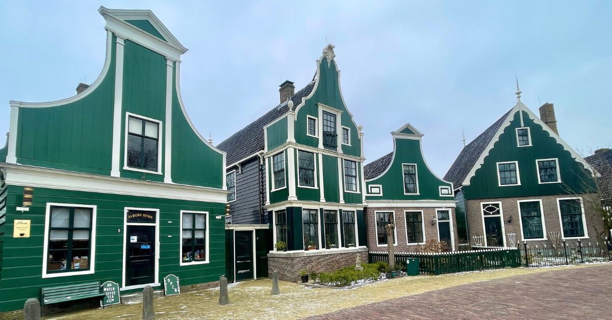 A row of green buildings in Amsterdam