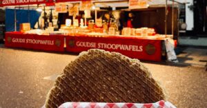 Image of a stroopwafel in Amsterdam being held in front of the shop