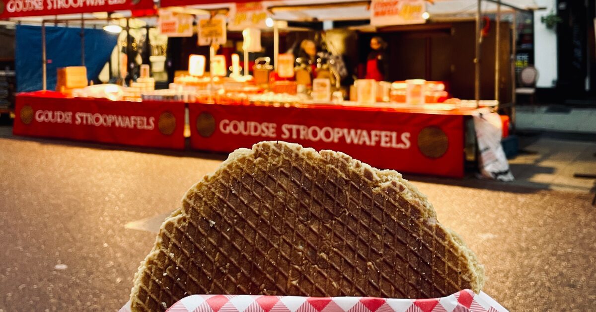 Image of a stroopwafel in Amsterdam being held in front of the shop