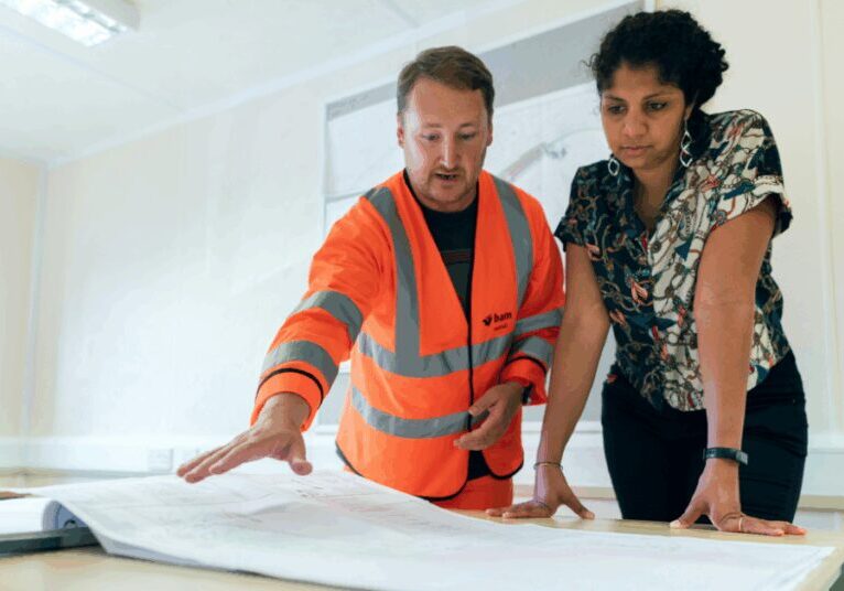 A contractor showing plans to their client