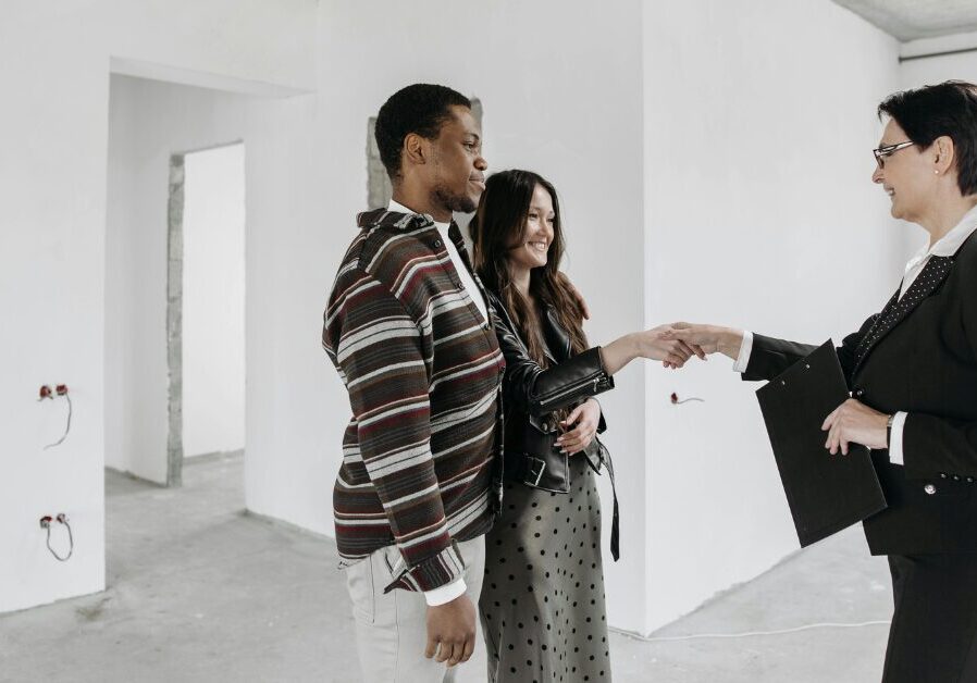 A couple buying a house from a real estate agent