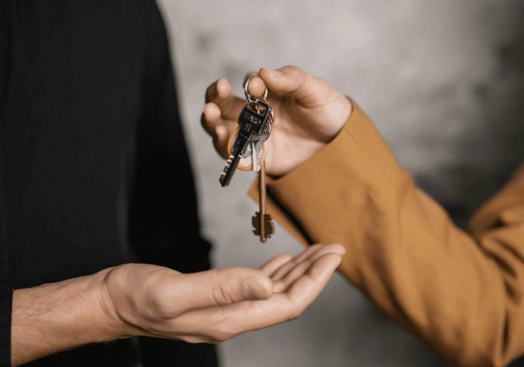 Two people exchanging a set of keys